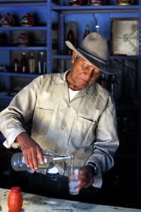 MEXICO Mezcal OAXACA State Tlacolula main street in the 'EL CORTIJO' Mezcal bar the owner pours himself a glass of Mezcal © Laurent Giraudou Anzenberger eyevine For further information contact eyevine tel: 020 8709 8709 email: info@eyevine.com