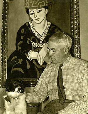 Albert Barnes and his dog in 1942, in front of ‘Red Madras Headdress’ (1907)
