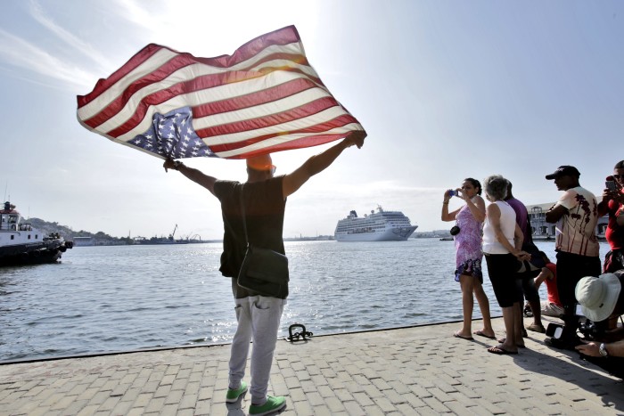 HAVANA, CUBA - MAY 2: Cuban Daniel Mikanda waves with an US flag upon the arrival of the cruise ship Adonia, the first US cruise ship in nearly forty years to arrive in Cuba, on May 2, 2016, in Havana, Cuba. The Adonia, belonging to the Carnival group, carried some 700 passengers on its sail from Miami to Havana, officially re-establishing the US cruise business in Cuba.(Photo by Sven Creutzmann/Mambo photo/Getty Images)