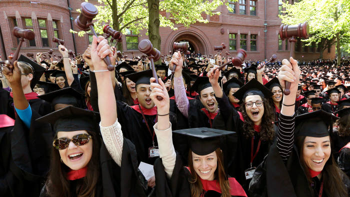 In this May 29, 2014 file photo, graduates from the Harvard Law School wave gavels and cheer during Harvard University commencement ceremonies, in Cambridge
