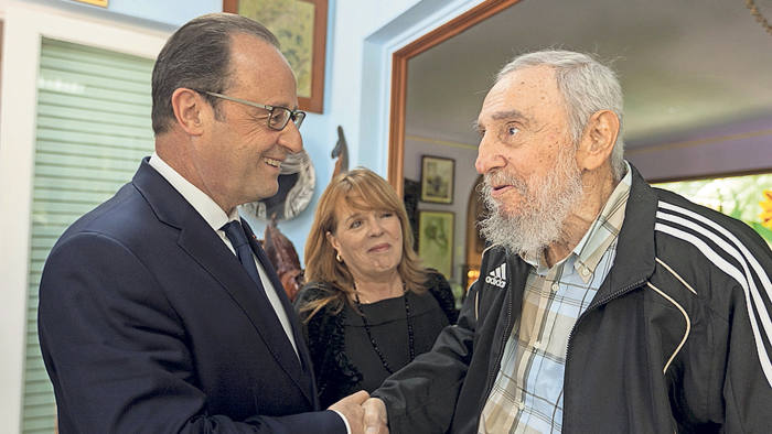 French President Francois Hollande (left) shakes hands with retired Cuban leader Fidel Castro during a private meeting in Havana, Cuba, May 11, 2015