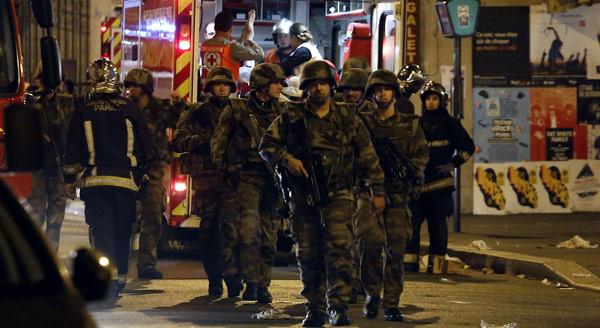 TOPSHOTS Soldiers walk in front of an am...TOPSHOTS Soldiers walk in front of an ambulance as rescue workers evacuate victims near La Belle Equipe, rue de Charonne, at the site of an attack on Paris on November 14, 2015 after a series of gun attacks occurred across Paris as well as explosions outside the national stadium where France was hosting Germany. More than 100 people were killed in a mass hostage-taking at a Paris concert hall and many more were feared dead in a series of bombings and shootings, as France declared a national state of emergency. AFP PHOTO / PIERRE CONSTANTPIERRE CONSTANT/AFP/Getty Images