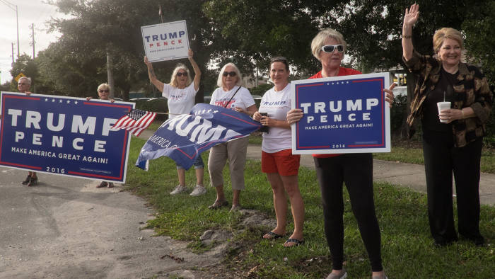 Campaigners waving signs in Altamonte Springs, Florida, including Burma Davis Posey (far right)