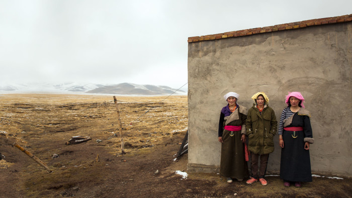 Tibetan women outside their home on the grassland, Qinghai province