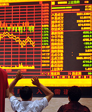 Chinese stock investors react as they monitor share prices at a securities firm in Fuyang, in China's Anhui province on June 19, 2015
