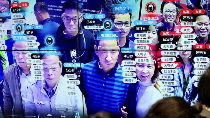 Visitors are seen at a screen displaying facial recognition technology at the Digital China Exhibition in Fuzhou, Fujian province, China May 8, 2019. China Daily via REUTERS ATTENTION EDITORS - THIS IMAGE WAS PROVIDED BY A THIRD PARTY. CHINA OUT. NO COMMERCIAL OR EDITORIAL SALES IN CHINA. TPX IMAGES OF THE DAY - RC184FE55330