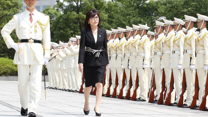 Tomomi Inada reviewing a guard of honour at the defence ministry last month