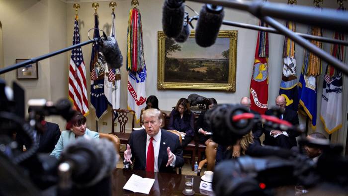 U.S. President Donald Trump, center, speaks as he meets with small business leaders in the Roosevelt Room of the White House in Washington, D.C., U.S., on Monday, Jan. 30, 2017. Trump defended the immigration clampdown that sparked a global backlash over the weekend by blaming the confusion at airports on protesters and on a computer outage at Delta Air Lines Inc. that caused flight cancellations. Photographer: Andrew Harrer/Bloomberg