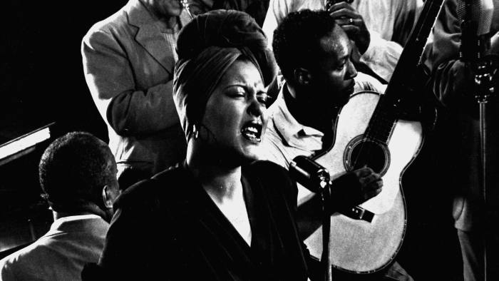 Closeup of Billie Holiday singing Fine & Mellow accompanied by James P. Johnson at piano & other unident. musicians during jam session in studio of LIFE photogrpher Gjon Mili. (Photo by Gjon Mili/The LIFE Picture Collection/Getty Images)