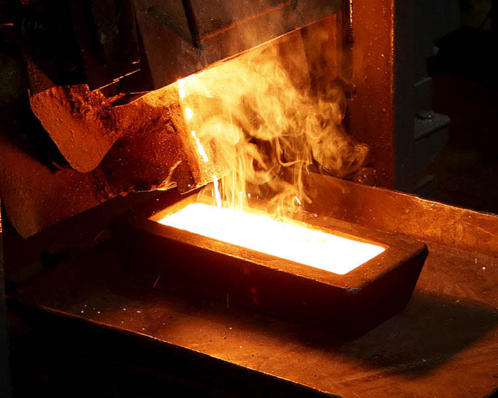 FILE PHOTO: A melter casts an ingot of 92.96 percent pure gold at a procession plant of the Olimpiada gold operation, owned by Polyus Gold International company, in Krasnoyarsk region, Eastern Siberia, Russia, June 30, 2015. Picture taken June 30, 2015. REUTERS/Ilya Naymushin/File Photo