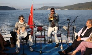 Corey Wilkes plays trumpet as part of a performance on the Bosphorus by Theaster Gates