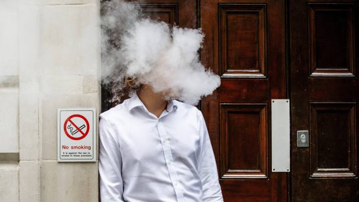 TOPSHOT - A smoker is engulfed by vapours as he smokes an electronic vaping machine during lunch time in central London on August 9, 2017.
World stock markets and the dollar slid Wednesday after US President Donald Trump warned of "fire and fury" in retaliation to North Korea's nuclear ambitions, sending traders fleeing to safe-haven investments. In Europe, equities dived with London losing 0.6 percent, while Frankfurt shed 1.1 percent and Paris fell 1.4 percent. / AFP PHOTO / Tolga Akmen        (Photo credit should read TOLGA AKMEN/AFP/Getty Images)
