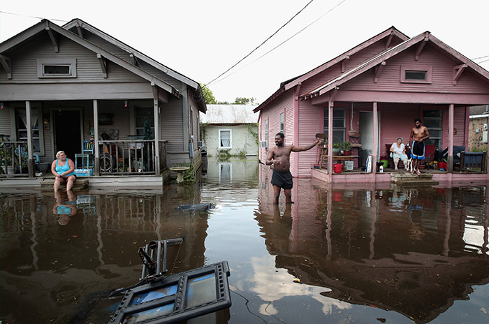 ORANGE, TX - SEPTEMBER 02: Residents hang out in front of their homes which are surrounded by floodwater after torrential rains pounded Southeast Texas following Hurricane and Tropical Storm Harvey causing widespread flooding on September 2, 2017 in Orange, Texas. Harvey, which made landfall north of Corpus Christi August 25, has dumped nearly 50 inches of rain in and around areas Houston. (Photo by Scott Olson/Getty Images) ***BESTPIX***