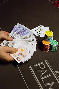 money, chips and cards on a poker table