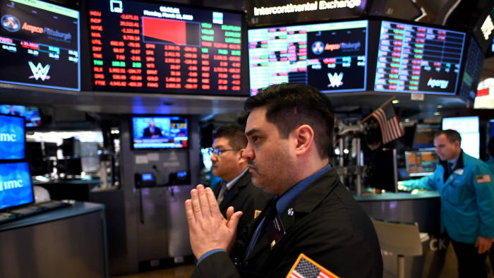 Traders work during the opening bell at the New York Stock Exchange (NYSE) on March 16, 2020 at Wall Street in New York City. - Trading on Wall Street was halted immediately after the opening bell Monday, as stocks posted steep losses following emergency moves by the Federal Reserve to try to avert a recession due to the coronavirus pandemic.Just after the opening bell, the S&P 500 was at 2,490.47, a drop of 8.1 percent and beyond the seven percent loss that automatically triggers a 15-minute trading halt. (Photo by Johannes EISELE / AFP) (Photo by JOHANNES EISELE/AFP via Getty Images)