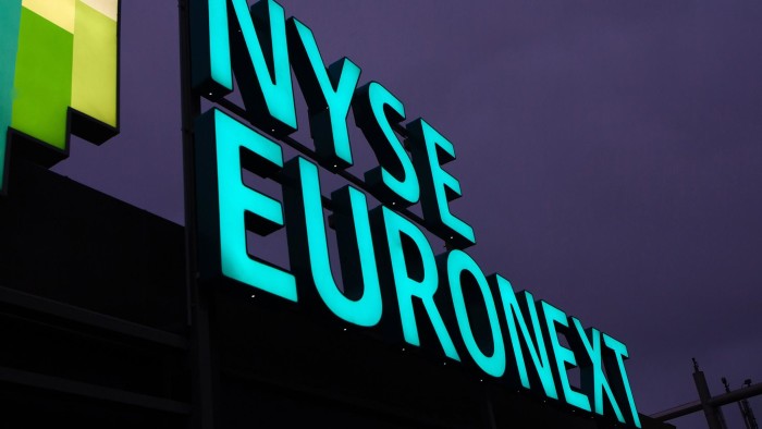 A sign stands illuminated above the offices of the NYSE Euronext Lisbon stock exchange in Lisbon, Portugal, on Thursday, July 11, 2013. NYSE Euronext, whose Liffe exchange is the biggest market for short-term interest rate derivatives, is vowing to restore confidence in the London benchmark Libor at the heart of the financial world's biggest scandal. Photographer: Mario Proenca/Bloomberg