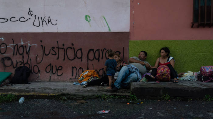 TAPACHULA, MEXICO - JUNE 19: Honduran migrants take shelter on a sidewalk on June 19, 2019 in Tapachula, Mexico. Since shelters in the city are over capacity, many migrants are living on sidewalks while they wait for their appointments to obtain a humanitarian visa. (Photo by Toya Sarno Jordan/Getty Images)