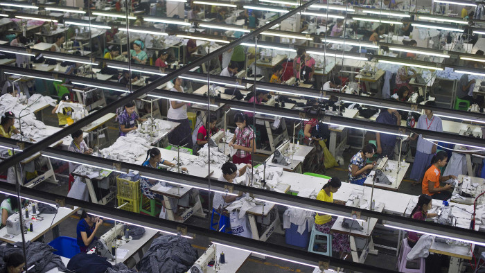 In this picture taken on September 18, 2015, employees work at a garment factory in the Shwe Pyi Thar industrial zone in Yangon