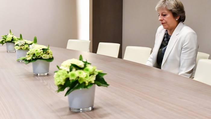 TOPSHOT - British Prime Minister Theresa May takes a seat as she arrives for a bilateral meeting with European Council President Donald Tusk during an EU summit in Brussels on October 20, 2017. The EU is expected to say that they will start internal preparatory work on a post-Brexit transition period and a future trade deal with Britain. / AFP PHOTO / POOL / Geert Vanden WijngaertGEERT VANDEN WIJNGAERT/AFP/Getty Images