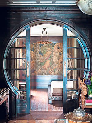 Circular sliding doors leading to art deco panel, designed by Hakan Ezer