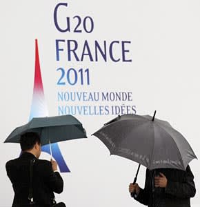 Taking cover: officials seek shelter ahead of a stormy G20 in Cannes