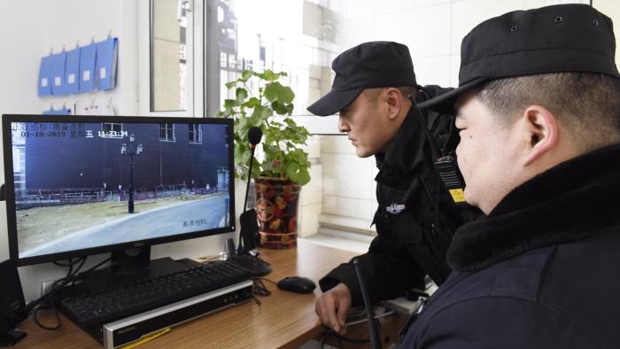 HOHHOT, CHINA - JANUARY 18: Security guards watch a video taken by a security robot at a community on January 18, 2019 in Hohhot, Inner Mongolia Autonomous Region of China. The security robots, equipped with panoramic camera and far infrared system, are able to communicate with people, recognize strangers and automatically alarm when noticing something abnormal. (Photo by Wang Zheng/VCG via Getty Images)
