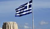 A Greek flag flutters atop the Acropolis in Athens on February 12, 2014. AFP PHOTO/ LOUISA GOULIAMAKI (Photo credit should read LOUISA GOULIAMAKI/AFP/Getty Images)