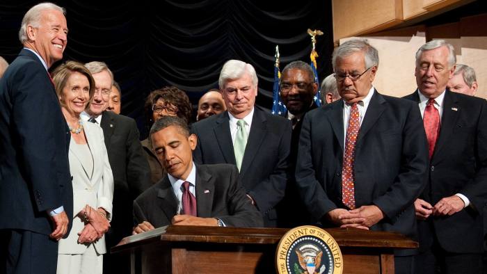 US President Barack Obama signs the Dodd-Frank Wall Street Reform and Consumer Protection Act alongside members of Congress and the administration including Connecticut Democrat Senator Chris Dodd (C), Massachusetts Democrat Representative Barney Frank (2nd R), Speaker of the House Nancy Pelosi (2nd L) and US Vice President Joe Biden (L), at the Ronald Reagan Building in Washington, DC, July 21, 2010. AFP PHOTO / Saul LOEB (Photo credit should read SAUL LOEB/AFP/Getty Images)