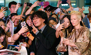 Bong Joon-ho and Tilda Swinton pose for photographs with fans at the film’s world premiere in Seoul