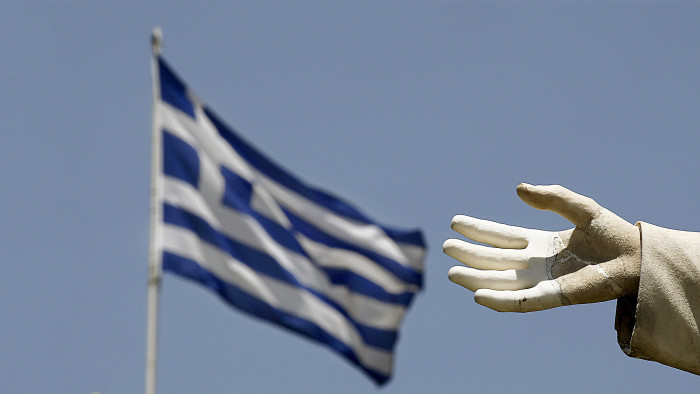 A Greek flag flutters by the hand of a statue of former British Prime Minister William Ewart Gladstone in Athens June 17, 2015. The Greek central bank warned on Wednesday that the country would be put on a &quot;painful course&quot; towards default and exiting the euro zone if the government and its international creditors failed to reach an agreement on an aid-for-reforms deal. REUTERS/Yannis Behrakis - RTX1GVXT
