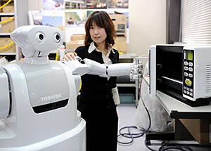 Japan is a leading developer of robots designed to help humans: Toshiba’s 'ApriAttenda' housekeeper can open a fridge door