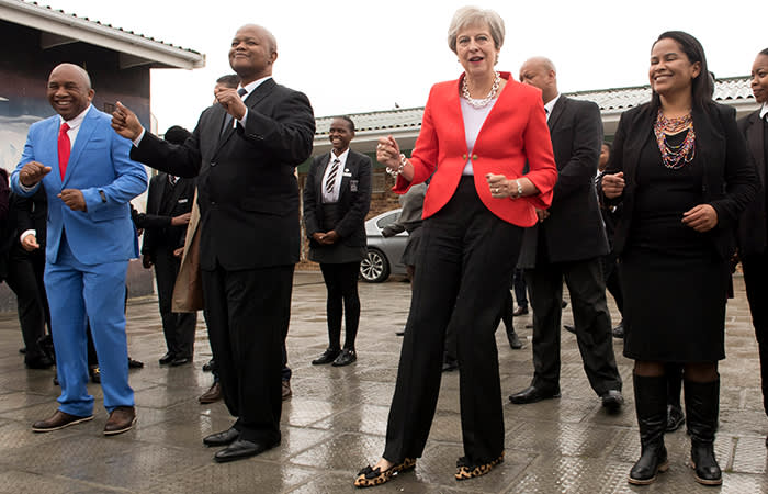 Prime Minister Theresa May dancing with students and staff at I.D. Mkize Secondary School in Cape Town, which is twinned with Whitby High School in Yorkshire. The two schools are part of a British Council funded teacher exchange scheme called 'Connected Classrooms'. The prime minister is on day one of her trip to South Africa, Nigeria and Kenya on a trade mission designed to bolster the UK's post-Brexit fortunes. PRESS ASSOCIATION Photo. Picture date: Tuesday August 28, 2018. See PA story POLITICS Africa. Photo credit should read: Stefan Rousseau/PA Wire