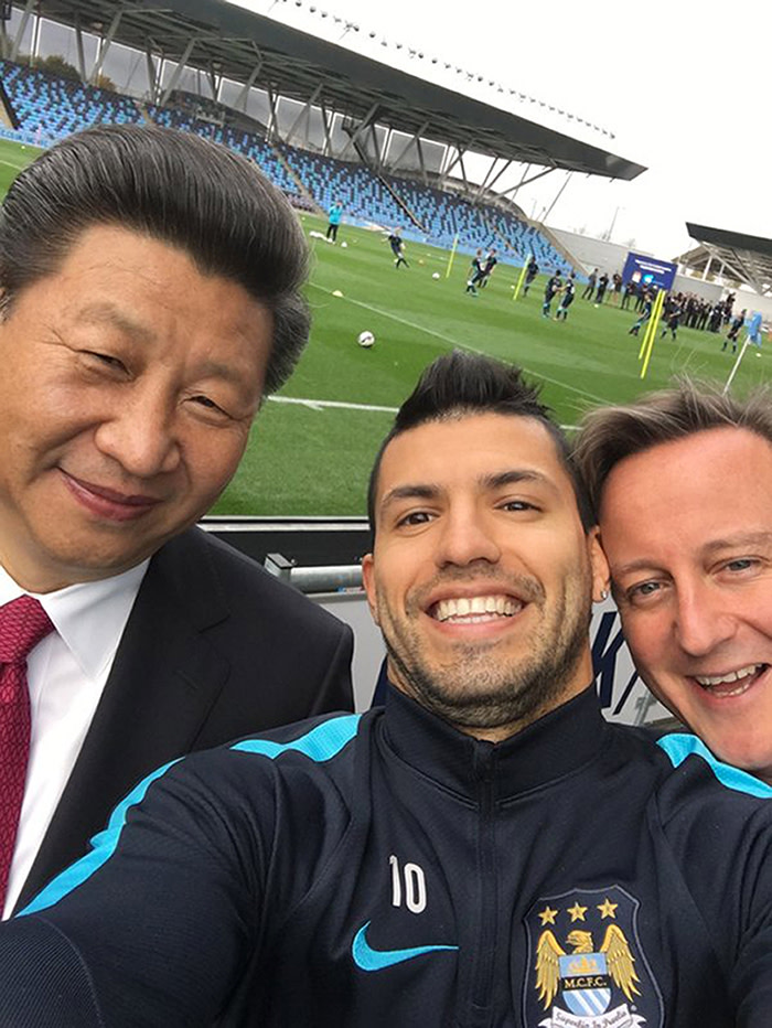 In this handout photo issued by Manchester City Football Club, soccer player Sergio Aguero takes a selfie with Britain's Prime Minister David Cameron, right, and Chinese President Xi Jinping, during a visit on the fourth day of his state visit, in Manchester, England, Friday Oct. 23, 2015. Chinese President Xi Jinping has been greeted by hundreds of enthusiastic and well-organized well-wishers in the northwest England city of Manchester. Crowds waving Chinese flags have greeted Xi throughout his four-day state visit to Britain, outnumbering pro-Tibet and human rights protesters concerned about the British government's lavish welcome for the Chinese leader. (Photo/Sergio Aguero, Manchester City Fooball Club via AP)