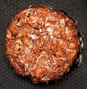 Meat-free burger patty being grilled
