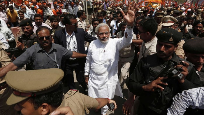 Hindu nationalist Narendra Modi (c), prime ministerial candidate for India's main opposition Bharatiya Janata Party (BJP), waves to his supporters as he arrives to file his nomination papers for the general elections in the northern Indian city of Varanasi April 24, 2014. Around 815 million people have registered to vote in the world's biggest election - a number exceeding the population of Europe and a world record - and results of the mammoth exercise, which concludes on May 12, are due on May 16. REUTERS/Adnan Abidi (INDIA - Tags: POLITICS ELECTIONS)