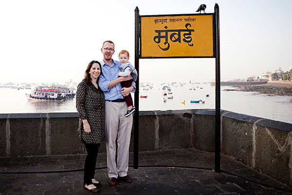 Mumbai, India- 12 March 2016: James, Mary and Alexander at Gateway of India next to a sign that says 'Mumbai'.
