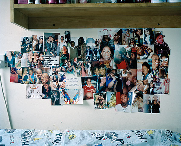 Photographs of friends and family above the bed