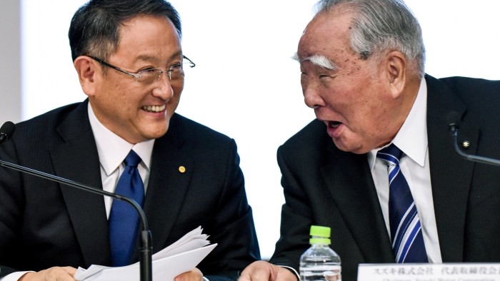 President of Toyota Motor Akio Toyoda (L) shares a laugh with Chairman of Suzuki Motor Osamu Suzuki (R) during a press conference at Toyota's head office in Tokyo on October 12, 2016. Toyota and Suzuki announced that it will consider the possibility of joint development of advanced technology. / AFP / TORU YAMANAKA (Photo credit should read TORU YAMANAKA/AFP/Getty Images)