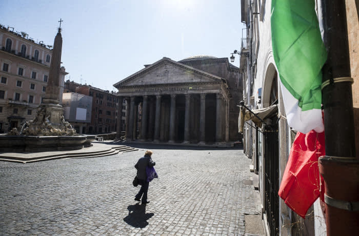 Mandatory Credit: Photo by ANGELO CARCONI/EPA-EFE/Shutterstock (10588163b) A woman with a protective face mask walks in front of the Pantheon during the emergency blockade of Covid-19 Coronavirus in Rome, Italy, 19 March 2020. Italy has reported at least 35,713 confirmed cases of the COVID-19 disease caused by the SARS-CoV-2 coronavirus and 2,978 deaths so far. The Mediterranean country remains in total lockdown as the pandemic disease spreads through Europe. Covid-19 Coronavirus emergency lockdown in Rome, Italy - 19 Mar 2020