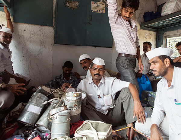 Kedari and fellow dabbawalas take a few moments’ rest in the luggage compartment of a train