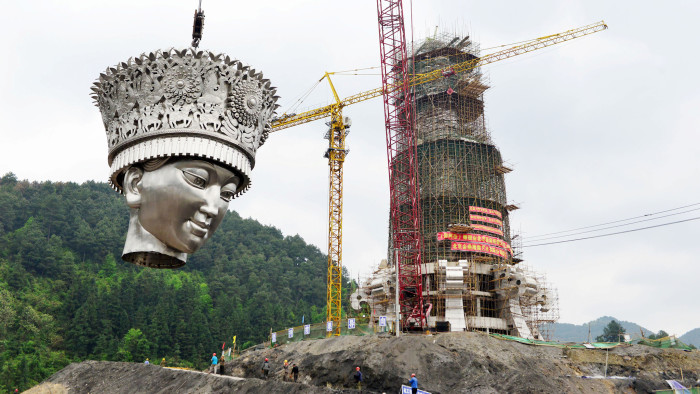 Head of a legendary ethnic Miao goddess statue is lifted at the construction site of the statue, in Jianhe County, Guizhou Province, April 15, 2017. Picture taken April 15, 2017. REUTERS/Stringer ATTENTION EDITORS - THIS IMAGE WAS PROVIDED BY A THIRD PARTY. EDITORIAL USE ONLY. CHINA OUT. NO COMMERCIAL OR EDITORIAL SALES IN CHINA.