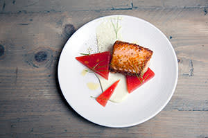A dish of salmon with watermelon and wasabi by 64 Degrees