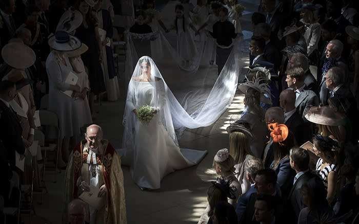 Meghan Markle walks down the aisle as she arrives for the wedding ceremony of Prince Harry and Meghan Markle at St. George's Chapel in Windsor Castle in Windsor, near London, England, Saturday, May 19, 2018. (Danny Lawson/pool photo via AP)