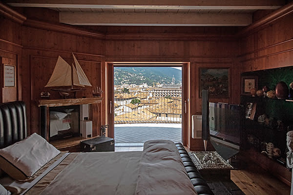 Wood-panelled bedroom with terrace overlooking Brescia