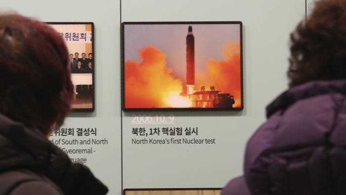 Visitors watch a photo showing North Korea's missile launch at the Unification Observation Post in Paju, South Korea, near the border with North Korea, Friday, Dec. 13, 2019. North Korea accused the United States of "hostile provocation" on Thursday for criticizing its ballistic missile tests during a United Security Council meeting and warned that the Trump administration may have blown its chance to salvage nuclear negotiations. (AP Photo/Ahn Young-joon)