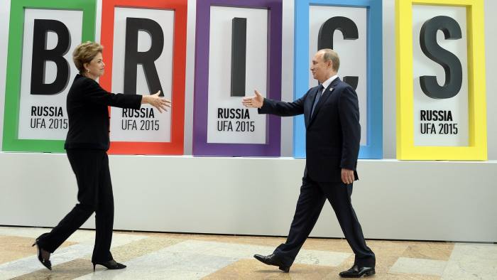Russia's President Vladimir Putin (R) greets Brazil's President Dilma Rousseff during a welcome ceremony in Ufa on July 9, 2015 at the start of the 7th BRICS summit. Leaders of the BRICS (Brazil, Russia, India, China and South Africa) group of emerging powers gathered in Ufa on Thursday to discuss regional and global issues, including the Syria conflict, threat of the Islamic State group, the situation in Greece and Iran's nuclear programme. AFP PHOTO / ALEXANDER NEMENOV (Photo credit should read ALEXANDER NEMENOV/AFP/Getty Images)