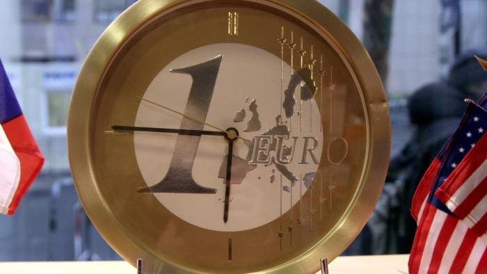 People walk by a clock with a euro face in a shop outside of a EU summit in Brussels on Monday, Jan. 30, 2012. The eurozone crisis will dominate an EU summit on Monday, with an emphasis on growth and budget discipline. (AP Photo/Virginia Mayo)