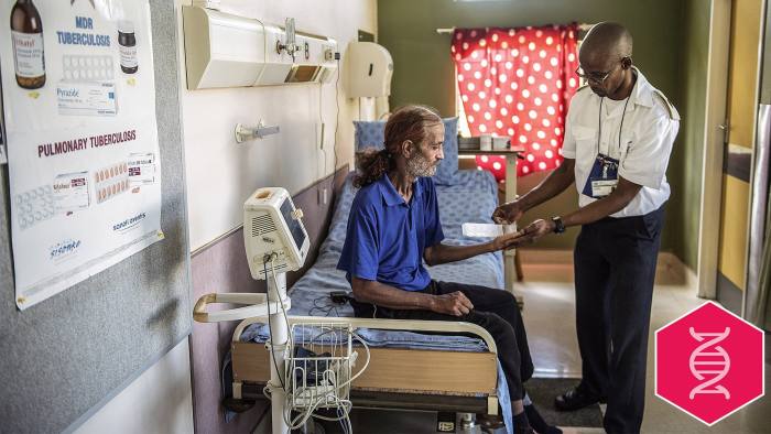 Former Tuberculosis affected patient Ashley McQuire receives his medication from a nurse at the Tshepong Hospital Tubercolosis ward on March 12, 2015 in Klerksdorp. He is one he first patients to have survived Extra Drugs Resistant (XDR) TB and he will leave the facility at the end of March. AFP PHOTO / MUJAHID SAFODIEN (Photo credit should read MUJAHID SAFODIEN/AFP/Getty Images)