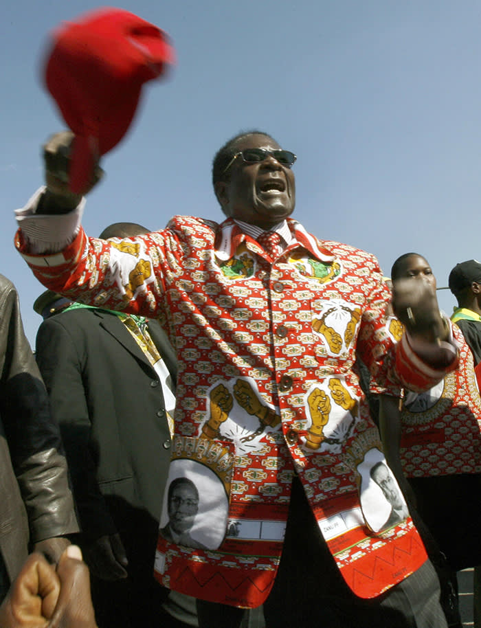 President Robert Mugabe greets supporters at his final rally. Mugabe used his campaign speech in Harare on June 26, 2008 on the eve of Zimbabwe's election to make a fresh offer to negotiate with the opposition after the ballot. AFP PHOTO / Alexander Joe (Photo credit should read ALEXANDER JOE/AFP/Getty Images)