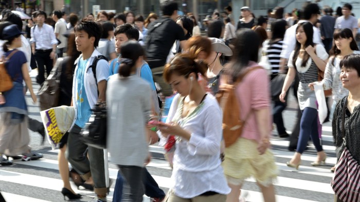 TO GO WITH AFP STORY 'Lifestyle-Asia-cities-Tokyo,FEATURE' by Frank Zeller Pedestrians cross a road in front of the Shibuya station in Tokyo on June 21, 2011. Tokyo dwarfs the other top megacities of Mumbai, Mexico City, Sao Paulo and New York, it has less air pollution, noise, traffic jams, litter or crime, lots of green space and a humming public transport system. AFP PHOTO / Yoshikazu TSUNO (Photo credit should read YOSHIKAZU TSUNO/AFP/Getty Images)